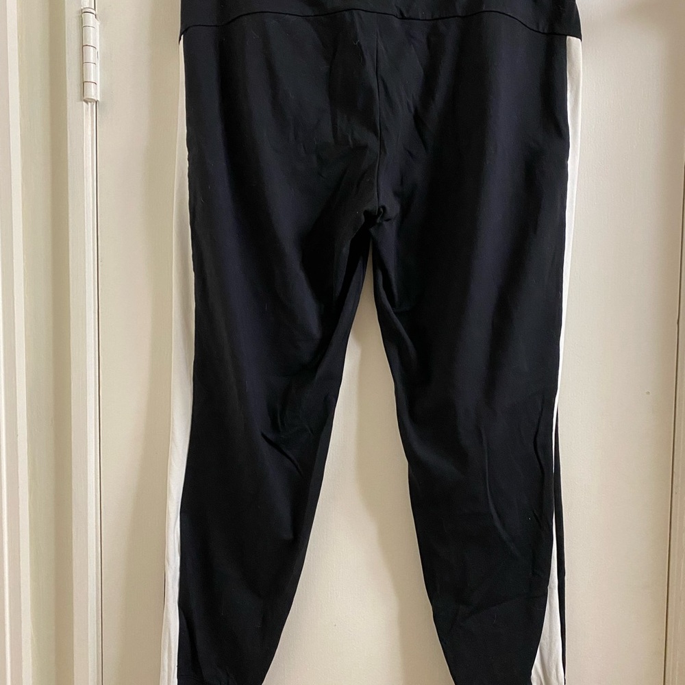 Athleta black joggers with white track stripe down the side
